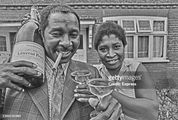 Pools winner Clement Thomas celebrates with a magnum of Laurent Perrier champagne, UK, 19th June 1974.