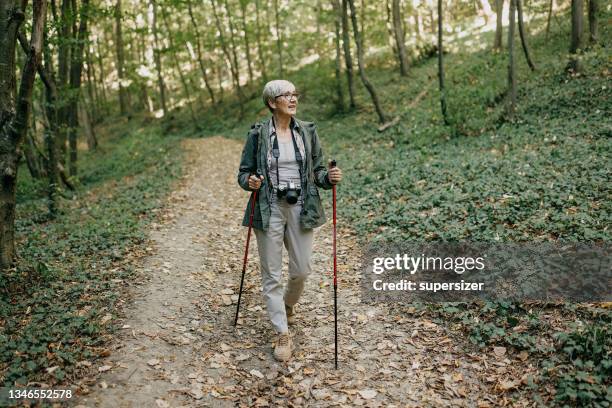 enjoying nature - senior woman walking stock pictures, royalty-free photos & images