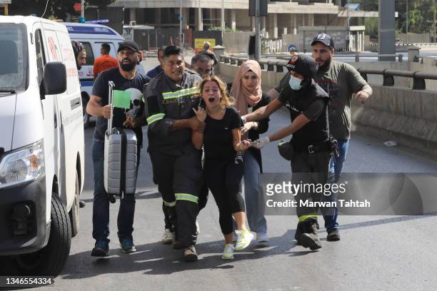 Medics evacuate residents after fierce fighting erupted near the Justice Palace in Beirut along a former civil war front line between Muslim Shiite...