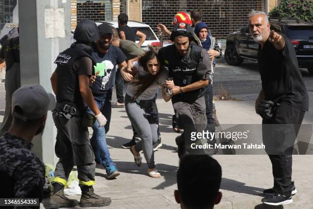 Medics evacuate residents after fierce fighting erupted near the Justice Palace in Beirut along a former civil war front line between Muslim Shiite...