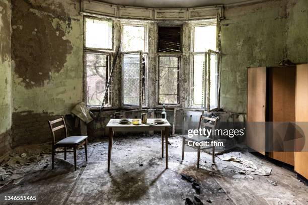 living room in bad condition in an abandoned building - old ruin stock pictures, royalty-free photos & images