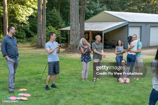 senior couple and adult children celebrating family reunion outdoors - friends social distancing stock pictures, royalty-free photos & images