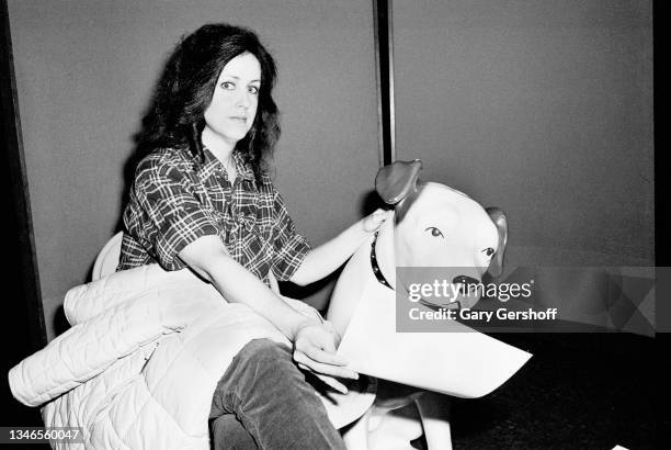 View of American Rock musician Grace Slick as she poses at RCA records, beside a plastic replica of Nipper, the company's long-time mascot , New...