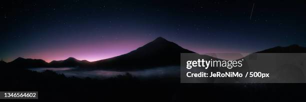 scenic view of silhouette of mountains against sky at night,taranaki,new zealand - dormant volcano stock-fotos und bilder