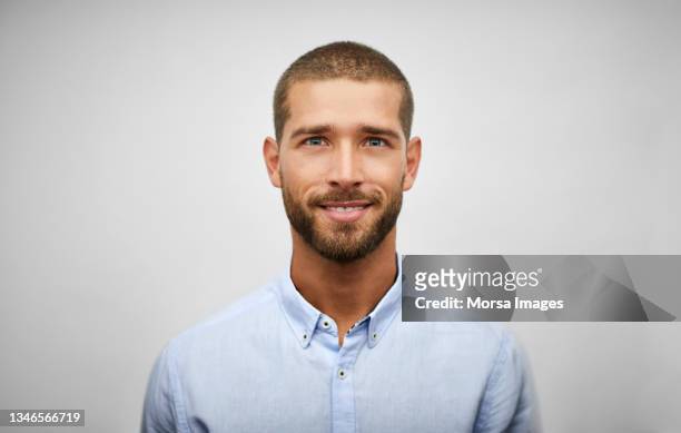 handsome young adult businessman with stubble - in den dreißigern stock-fotos und bilder