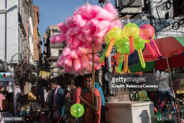 Nepali vendor selling balloons and candy floss waits for customers in a market outside Durbar Square on October 14, 2021 in Kathmandu, Nepal. Nepal's...