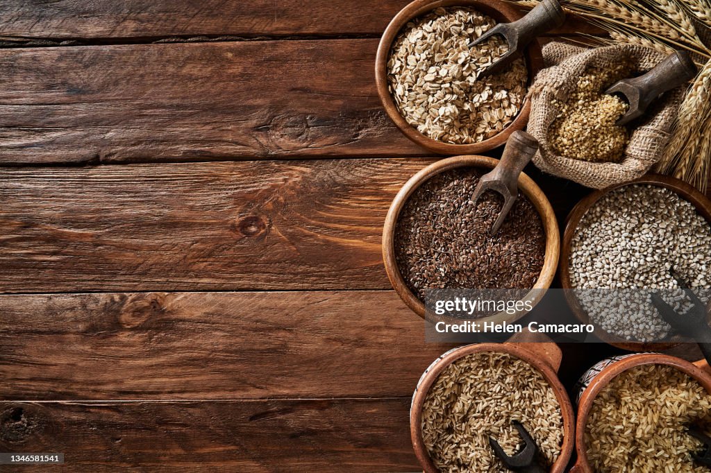 Dietary fiber: variety of cereals on rustic wooden background with copy space.