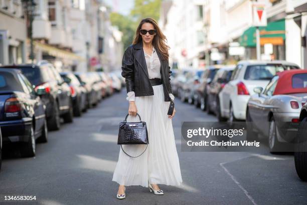 Alexandra Lapp is seen wearing Saint Laurent leather jacket, white blouse and pleated maxi skirt Gabriela Hearst, Hermes Kelly bag crocodile, heels...