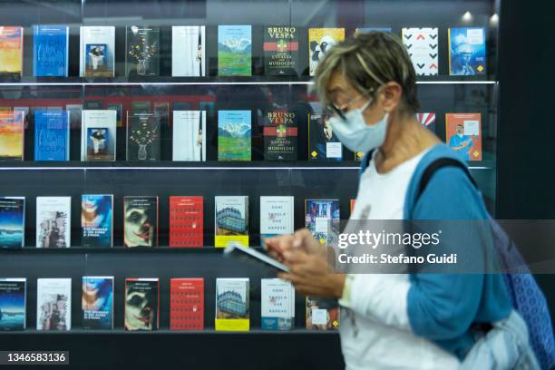 Woman looks at books during the Turin International Book Fair on October 14, 2021 in Turin, Italy. The Turin International Book Fair returns to...