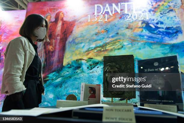 Visitors wearing a face mask view books on display during the Turin International Book Fair on October 14, 2021 in Turin, Italy. The Turin...