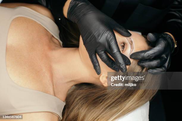 permanent make up treatment - eyebrow shaping stock pictures, royalty-free photos & images