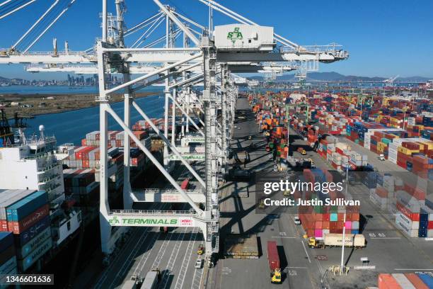 Shipping containers are stacked on a dock at the Port of Oakland on October 14, 2021 in Oakland, California. Disruptions to the global supply chain...