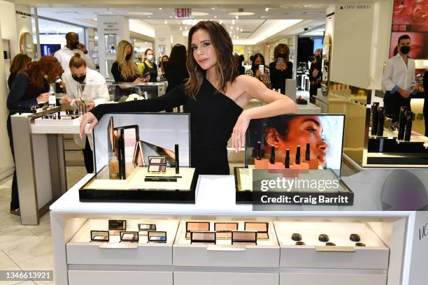Victoria Beckham poses with a display of Victoria Beckham Beauty as Bergdorf Goodman Celebrates Victoria Beckham Beauty on October 14, 2021 in New...
