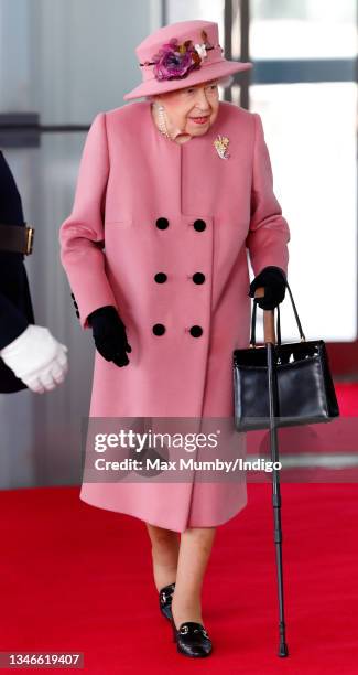 Queen Elizabeth II seen using a walking stick as she attends the opening ceremony of the sixth session of the Senedd at The Senedd on October 14,...