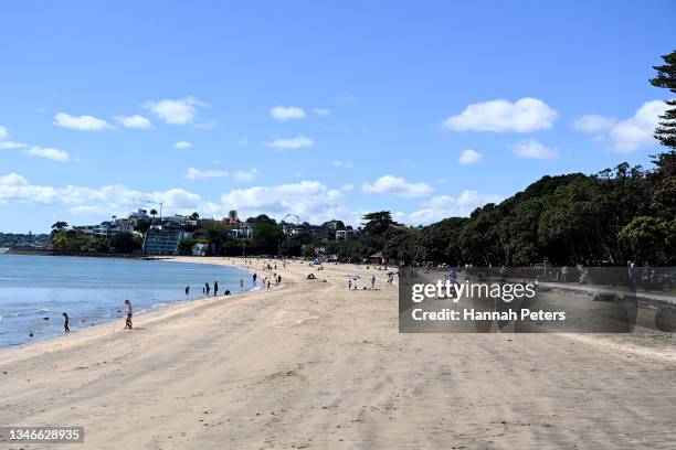 People gather at Mission Bay beach on October 15, 2021 in Auckland, New Zealand. Auckland remains at COVID-19 Alert Level 3 with residents only...