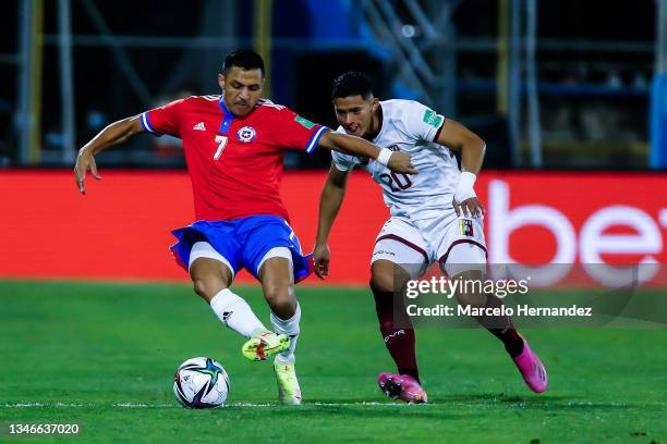 Alexis Sánchez of Chile fights for the ball with Ronald Hernandez of Venezuela during a match between Chile and Venezuela as part of South American...