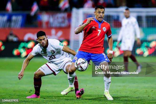 Alexis Sánchez of Chile fights for the ball with Ronald Hernandez of Venezuela during a match between Chile and Venezuela as part of South American...
