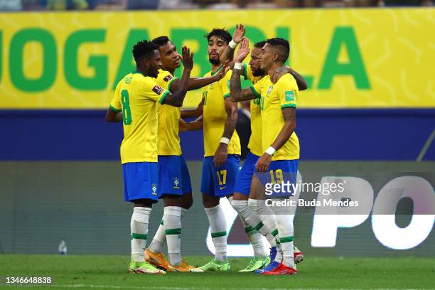 Raphinha of Brazil celebrates with teammates after scoring the third goal of his team during a match between Brazil and Uruguay as part of South...