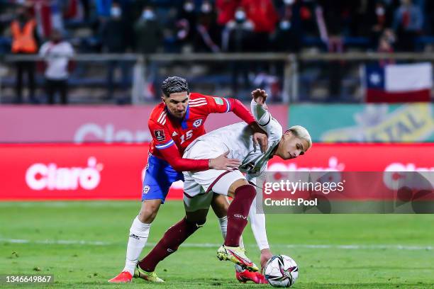 Diego Valdés of Chile fights for the ball with Eric Ramírez of Venezuela during a match between Chile and Venezuela as part of South American...