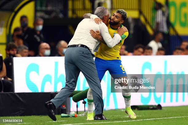 Gabriel Barbosa of Brazil celebrates with head coach Tite after scoring the fourth goal of his team during a match between Brazil and Uruguay as part...