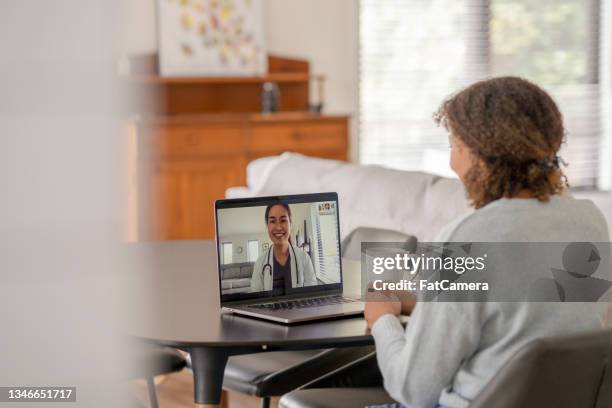 patient meeting remotely with her doctor - telemedicine patient stock pictures, royalty-free photos & images