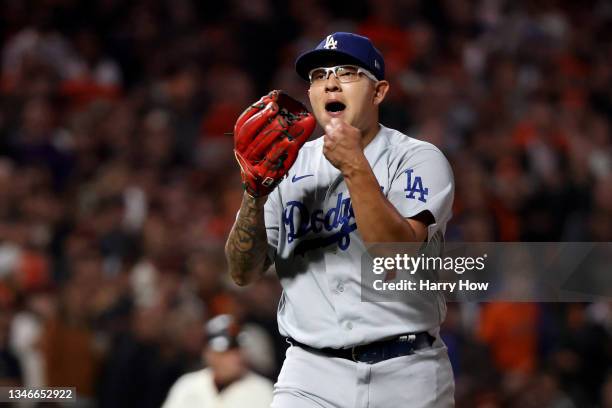 Julio Urias of the Los Angeles Dodgers reacts after the third out of the fourth inning against Wilmer Flores of the San Francisco Giants in game 5 of...