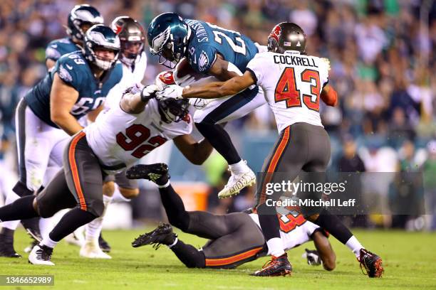 Running back Miles Sanders of the Philadelphia Eagles is tackled by defensive end William Gholston and cornerback Ross Cockrell of the Tampa Bay...