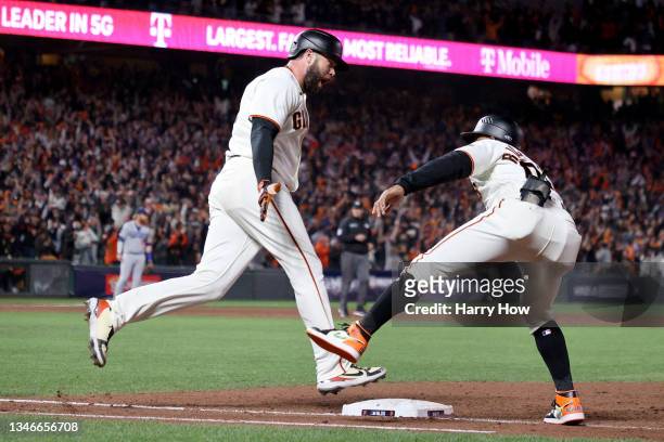 Darin Ruf celebrates his solo home run with first base coach Antoan Richardson of the San Francisco Giants against the Los Angeles Dodgers during the...