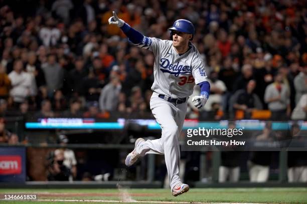 Cody Bellinger of the Los Angeles Dodgers celebrates his RBI single to score Justin Turner against the San Francisco Giants during the ninth inning...
