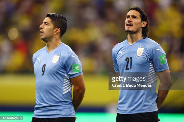 Luis Suarez and Edinson Cavani of Uruguay sing the national anthem prior to a match between Brazil and Uruguay as part of South American Qualifiers...