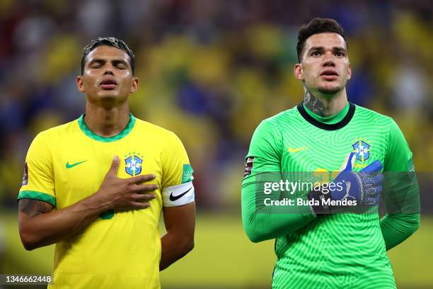 Thiago Silva and Ederson of Brazil sing the national anthem prior to a match between Brazil and Uruguay as part of South American Qualifiers for...