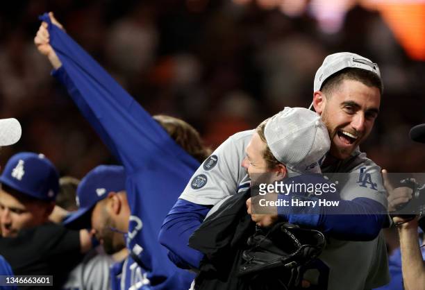 Gavin Lux holds up Cody Bellinger of the Los Angeles Dodgers as they celebrate their 2-1 win against the San Francisco Giants in game 5 of the...