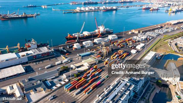 high angle shot of cargo being transported by ship in a harbour - busy platform stock pictures, royalty-free photos & images