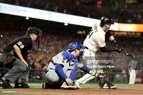 Wilmer Flores of the San Francisco Giants strikes out on a checked swing for the final out of the game against the Los Angeles Dodgers during the...