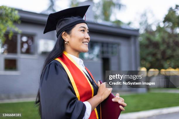 proud female university student graduate - graduation stockfoto's en -beelden