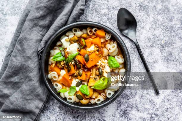 pasta with pumpkin, carrots and mushrooms - lunch stock-fotos und bilder