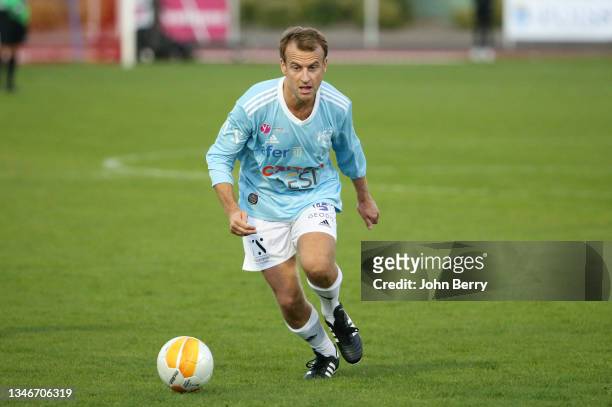 French President Emmanuel Macron playing with VCF during the charity football match between Varietes Club de France and CHI PSG , to benefit...