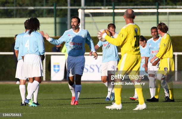 Robert Pires of VCF celebrates his goal with teammates during the charity football match between Varietes Club de France and CHI PSG , to benefit...