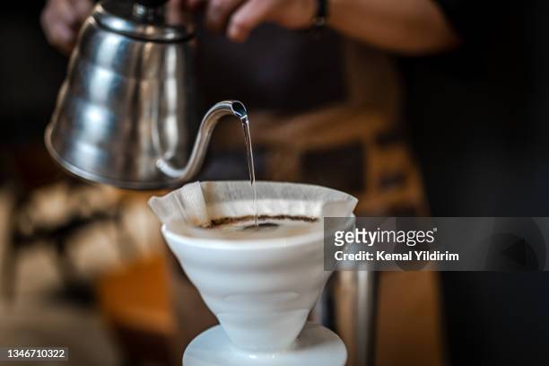 close up of hand brewing coffee - decaffeinated stock pictures, royalty-free photos & images