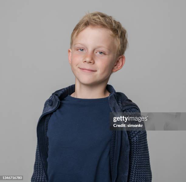 smiling boy wearing blue jacket - navy shirt stock pictures, royalty-free photos & images