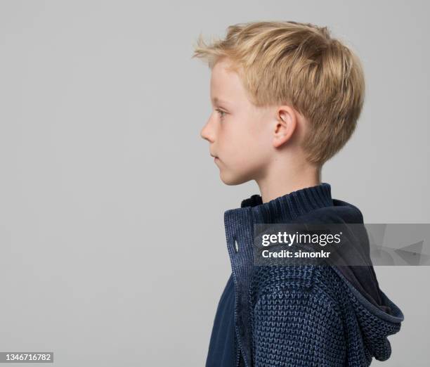 profile of boy wearing blue jacket - serious kid stock pictures, royalty-free photos & images