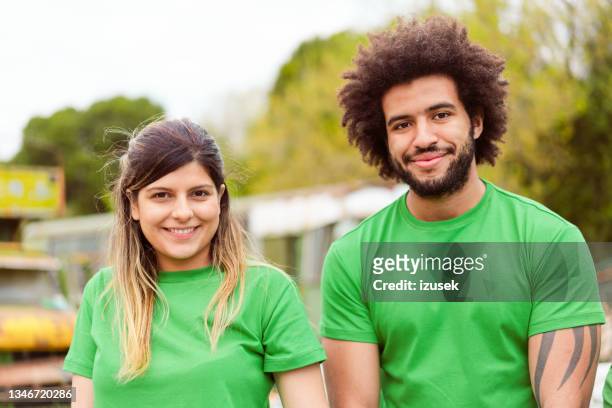 male and female volunteering for cleanup in park - environmentalist stock pictures, royalty-free photos & images