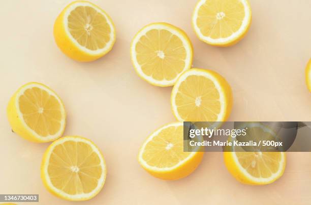 high angle view of lemons on table - cut lemon stockfoto's en -beelden