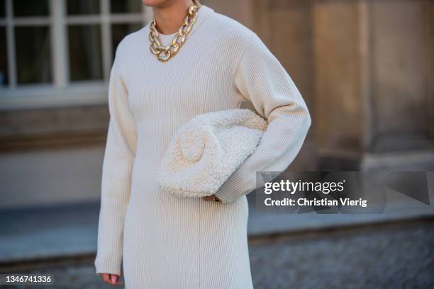 Tina Haase is seen wearing Joseph cream knit dress, Sacha beige combat Boots, Uterque chain necklace, COS shearling bag on October 15, 2021 in...