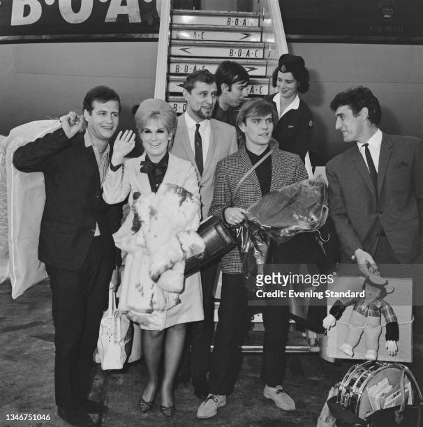 English singer Dusty Springfield and her backing band The Echoes arrive back at London Airport , in the UK, having been expelled from South Africa...