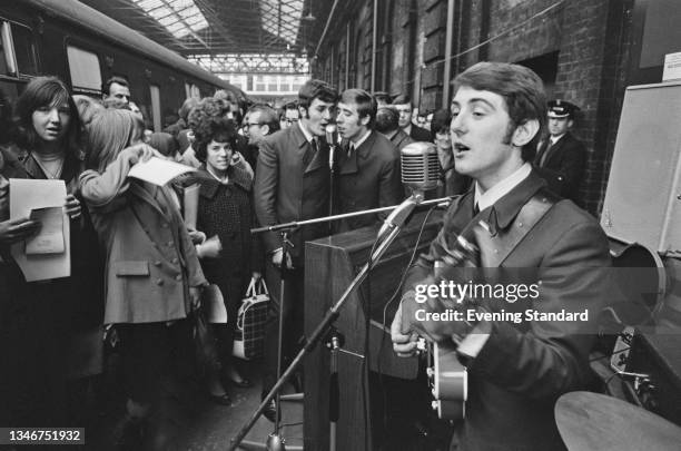 English rock band the Moody Blues perform live at Holborn Viaduct station in London, UK, 11th November 1964. Singer Denny Laine is in the foreground,...