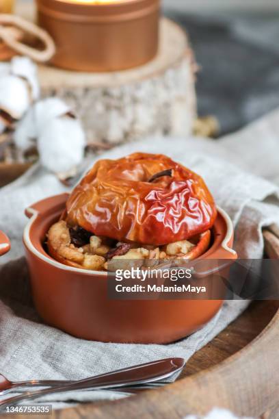 baked apple dessert with cinnamon, raisins and nuts - apple plate stock pictures, royalty-free photos & images