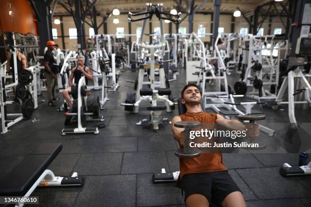 Gabriel Carvalho works out without a face mask a Fitness SF gym on October 15, 2021 in San Francisco, California. The City and County of San...