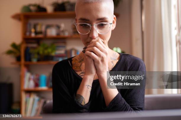 shot of a young woman sitting at home - unhappy woman blonde glasses stock pictures, royalty-free photos & images