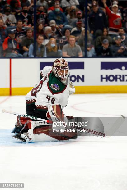 Carter Hutton of the Arizona Coyotes makes a save during the game against the Columbus Blue Jackets at Nationwide Arena on October 14, 2021 in...